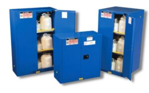 Three blue hazmat cabinets from Justrite Safety Group in blue color and containing small 1-gallon containers of chemicals