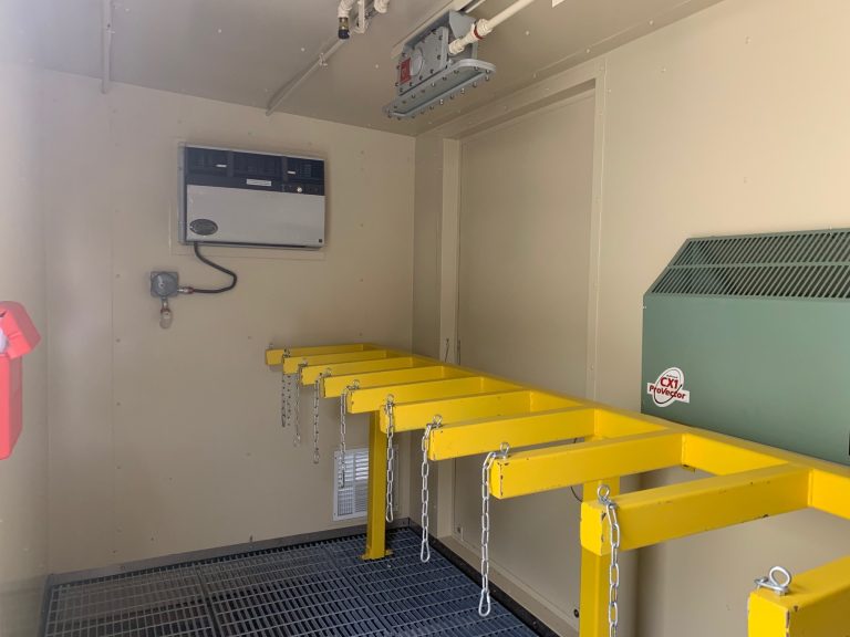 A row of gas cylinder racks in a chemical storage building featuring A/C and head as well as ceiling fire suppression and LED lighting