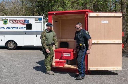 Two officers moving a type 3 day box from within a type 2 explosive magazine from U.S. Chemical Storage